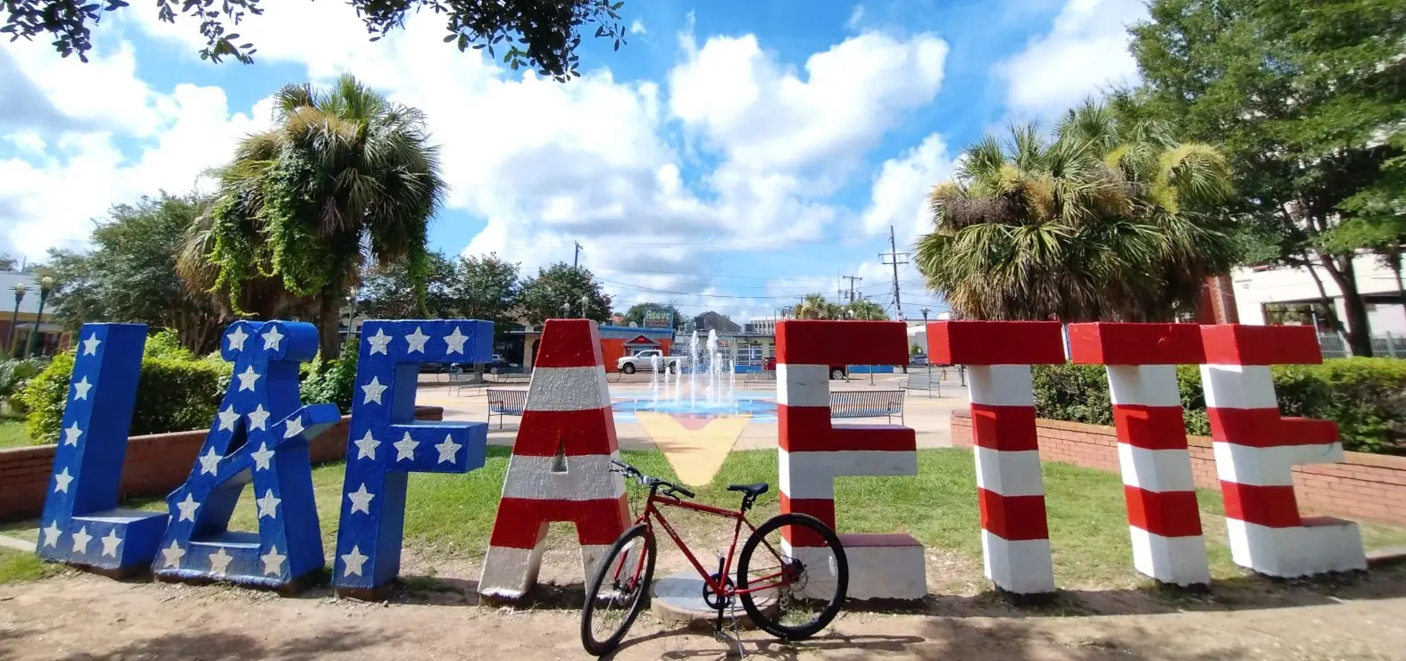 Colorful Lafayette sign and bicycle under a blue Louisiana sky
