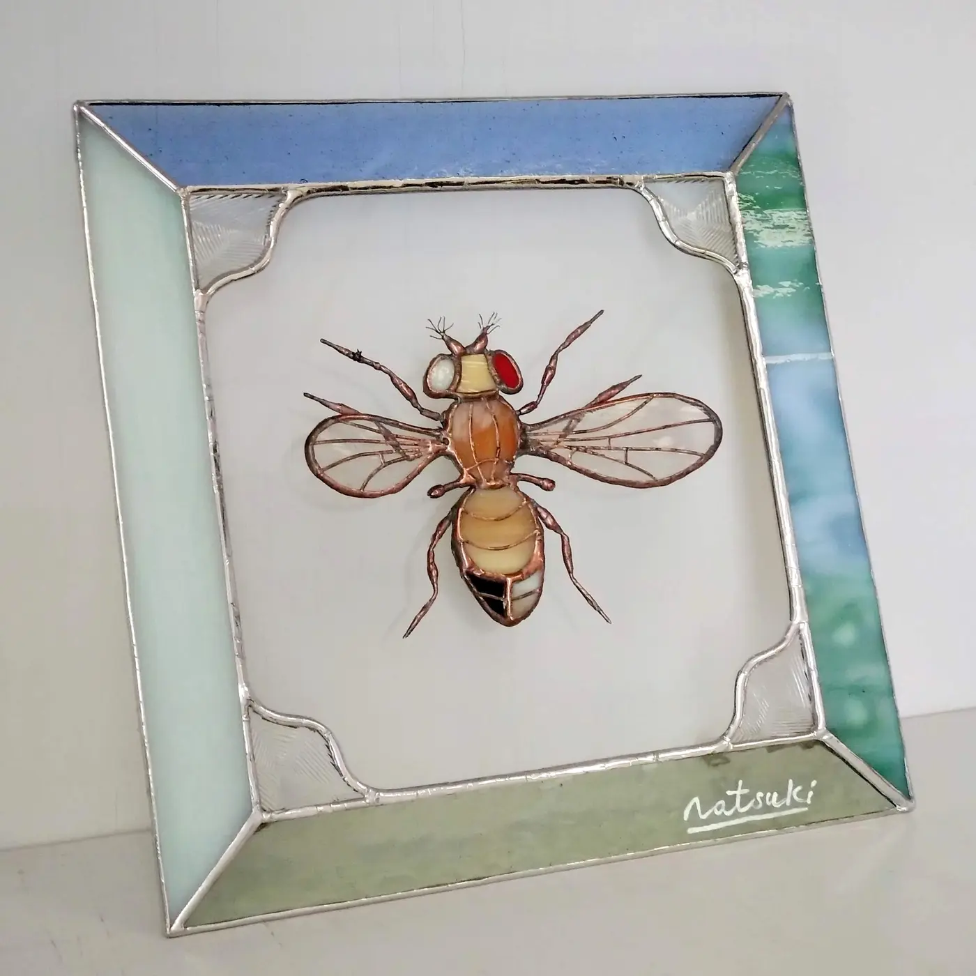 Stained-glass artwork of a Drosophila fruit fly